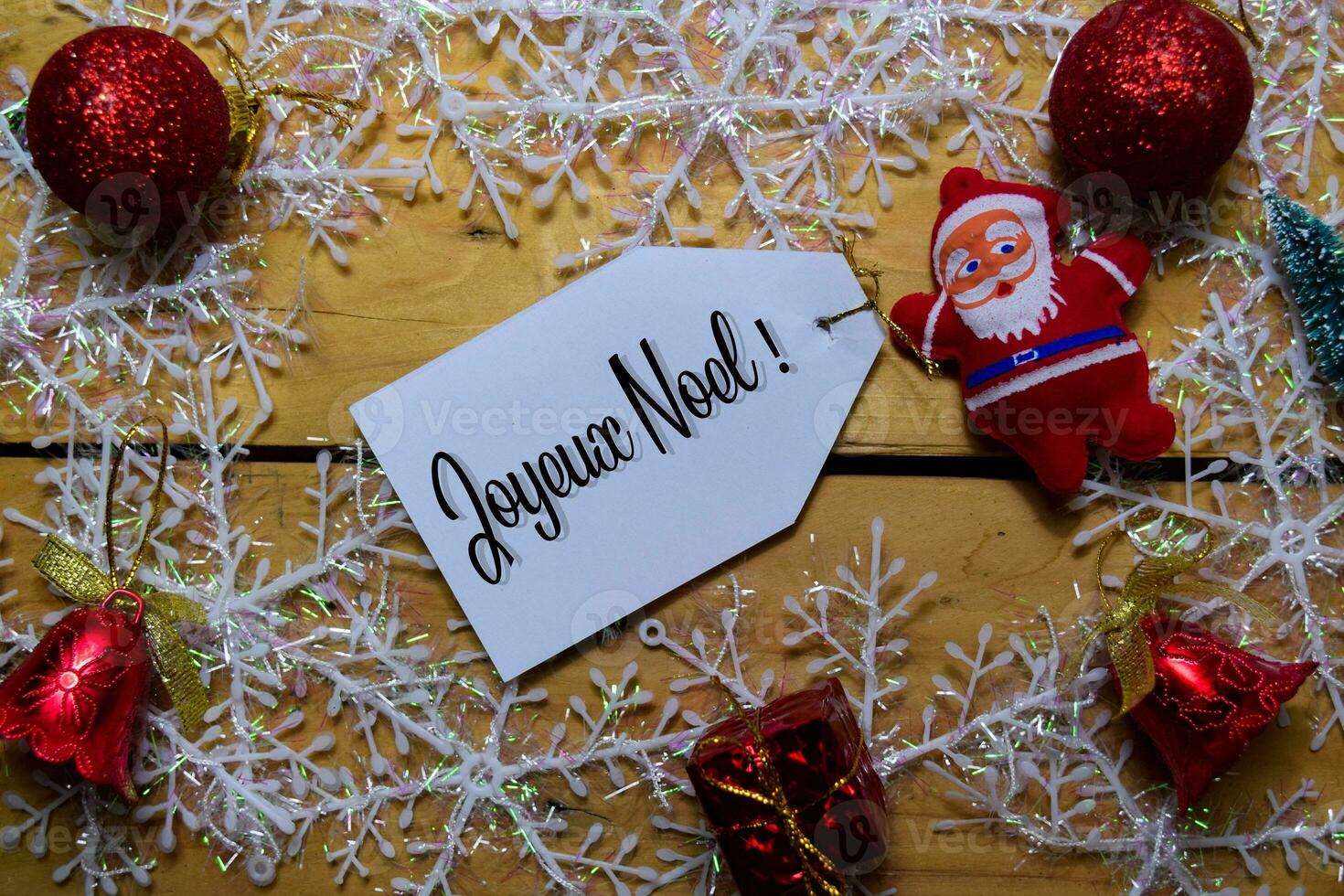 Joyeux Noel write on label with wooden backgroud. It means Merry Christmas. Frame of Christmas Decoration. photo