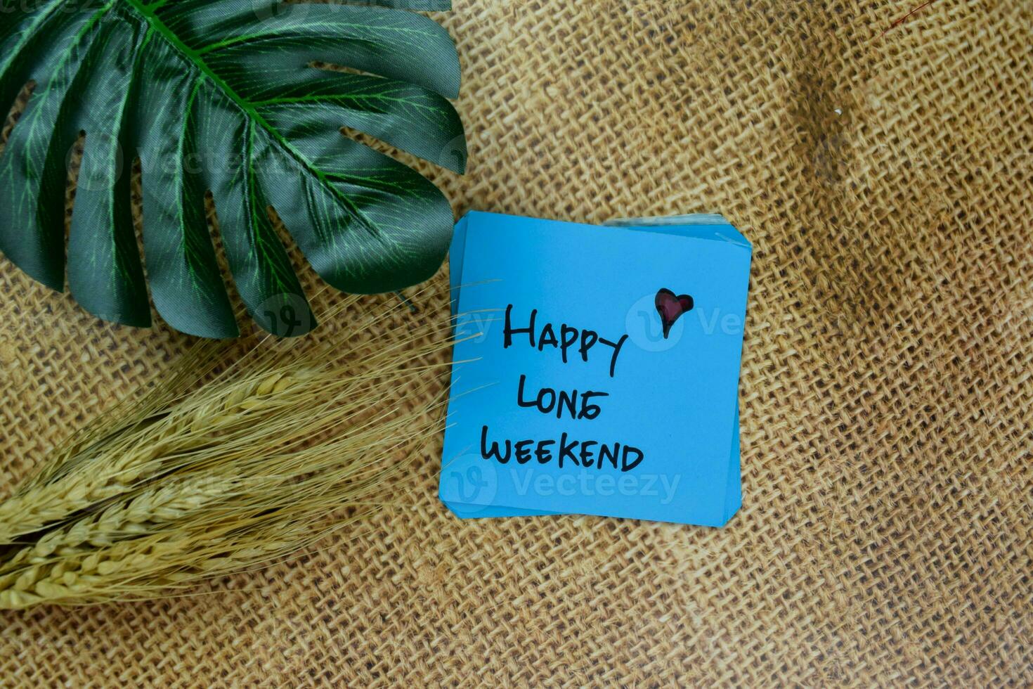 Happy Long Weekend write on sticky notes isolated on Wooden Table. photo