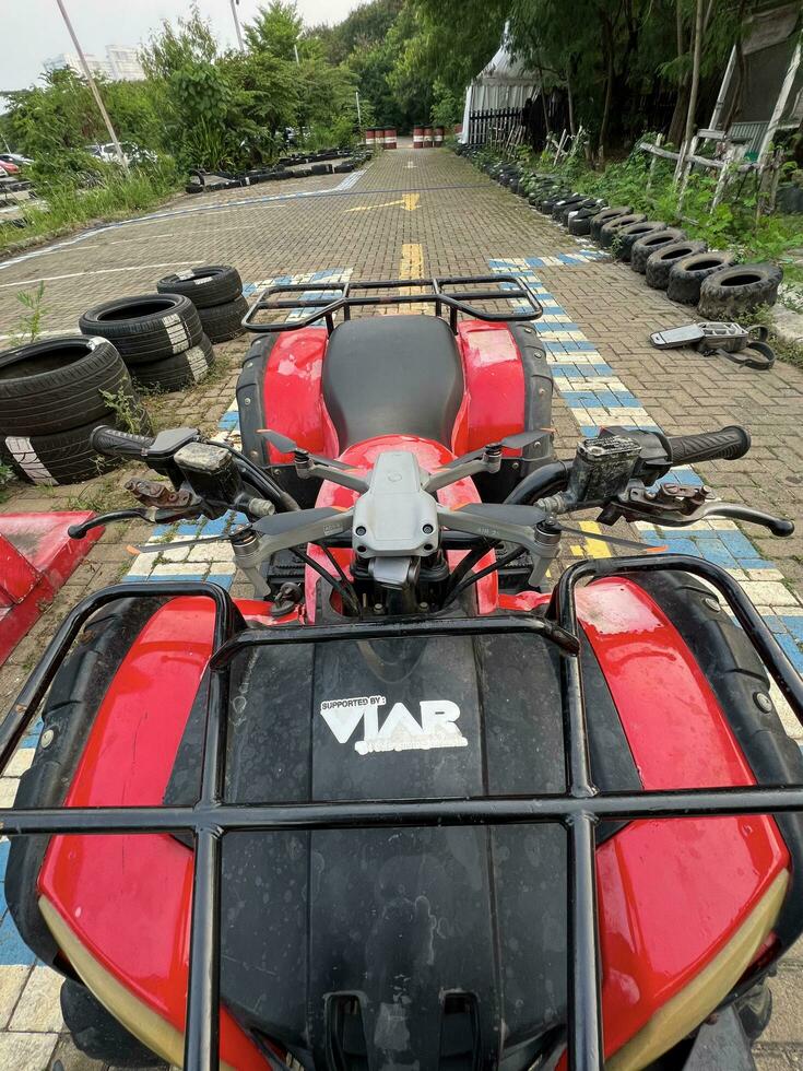 ATV awd quadbike motorcycle and cloudscape sky background. Offroad adventure trip . Extreme sport activity. Bekasi, Indonesia, September 30, 2022 photo