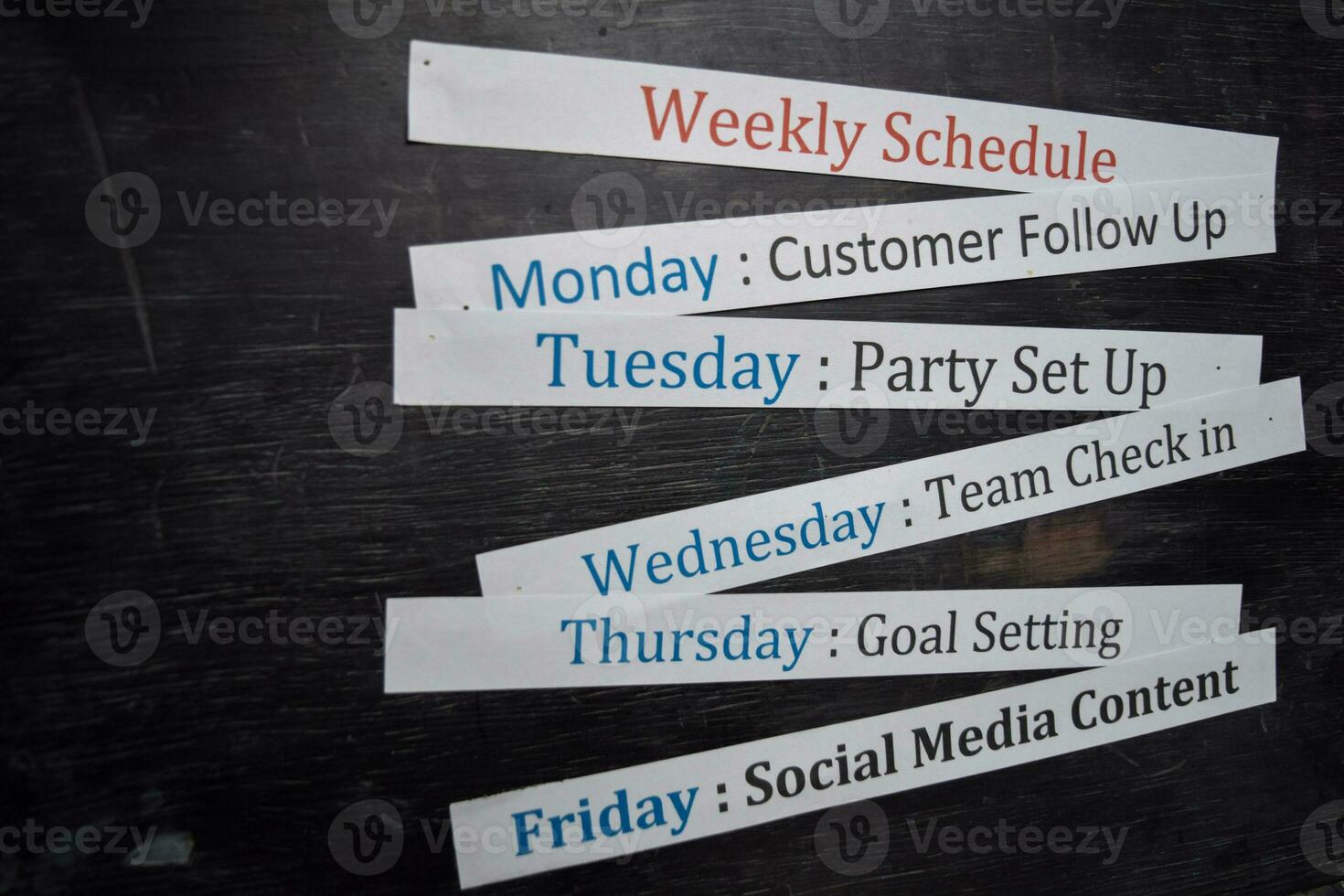 Close up making agenda weekly schedule on personal organizer. Business and entrepreneur concept. Isolated on blackboard photo