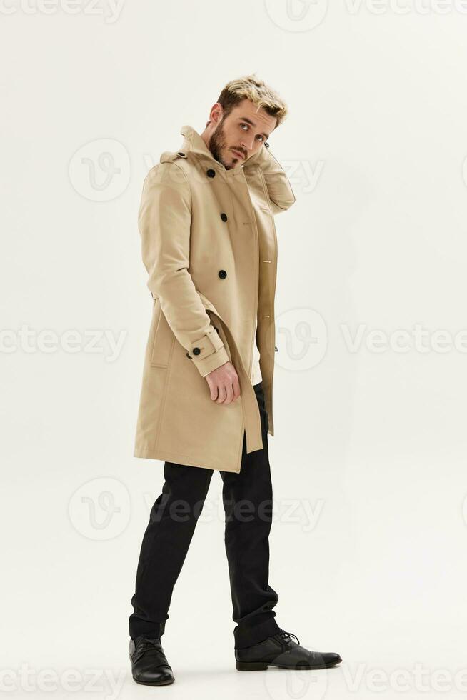 man in beige coat modern style lifestyle isolated background photo