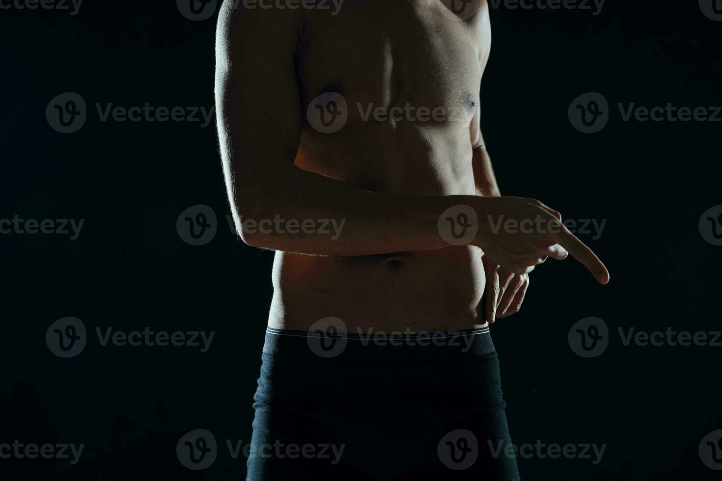 sports man with pumped up abs workout motivation dark background photo