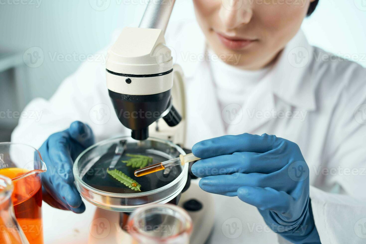 female laboratory assistant adjusts microscope research chemical solutions science photo