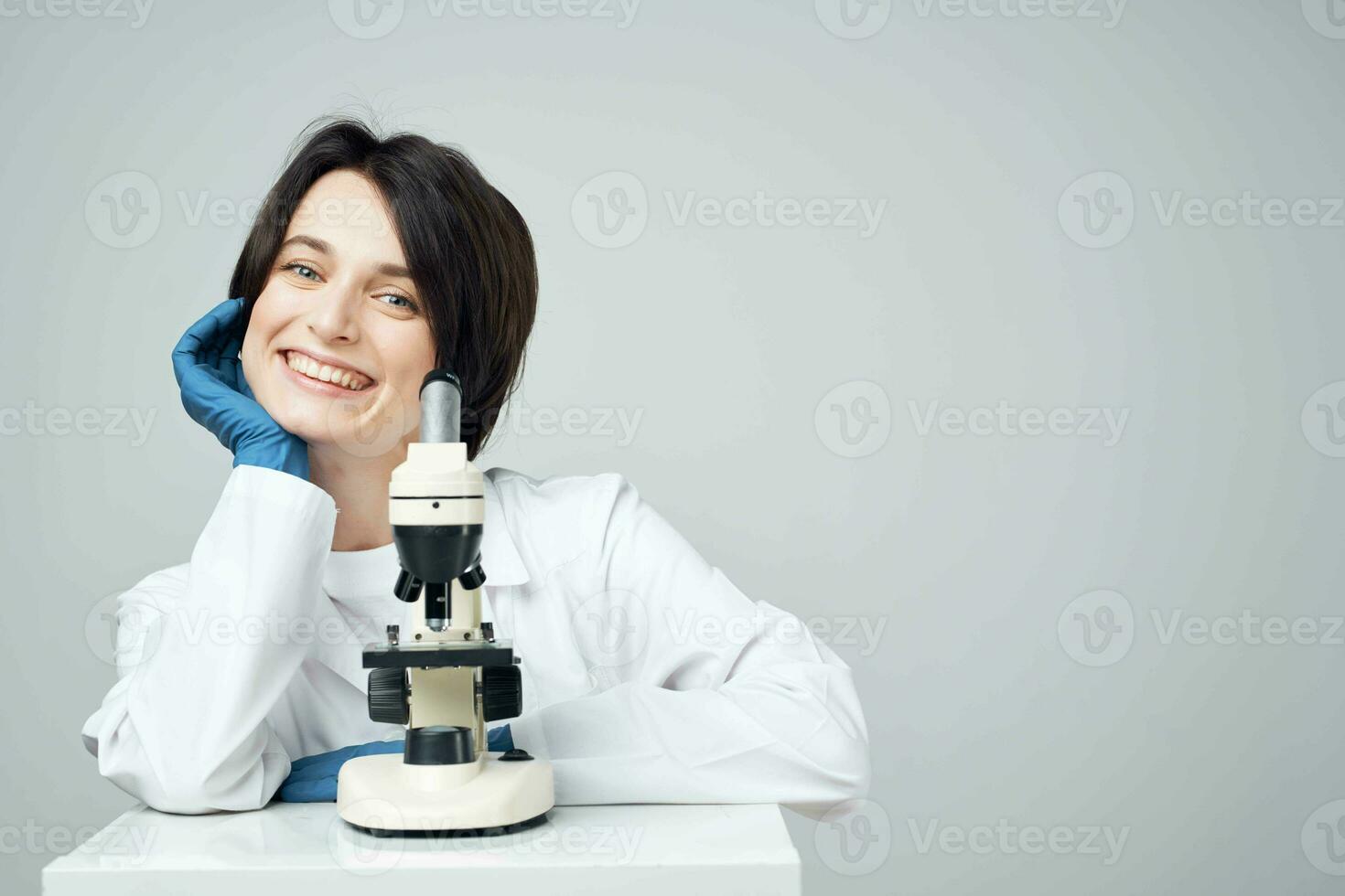 female scientist in white coat laboratory microscope science experiment photo