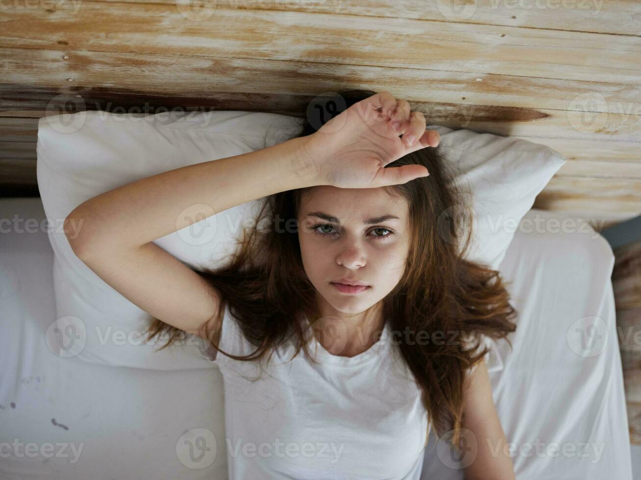 woman lying in bed feeling unwell temperature dissatisfaction 23656370
