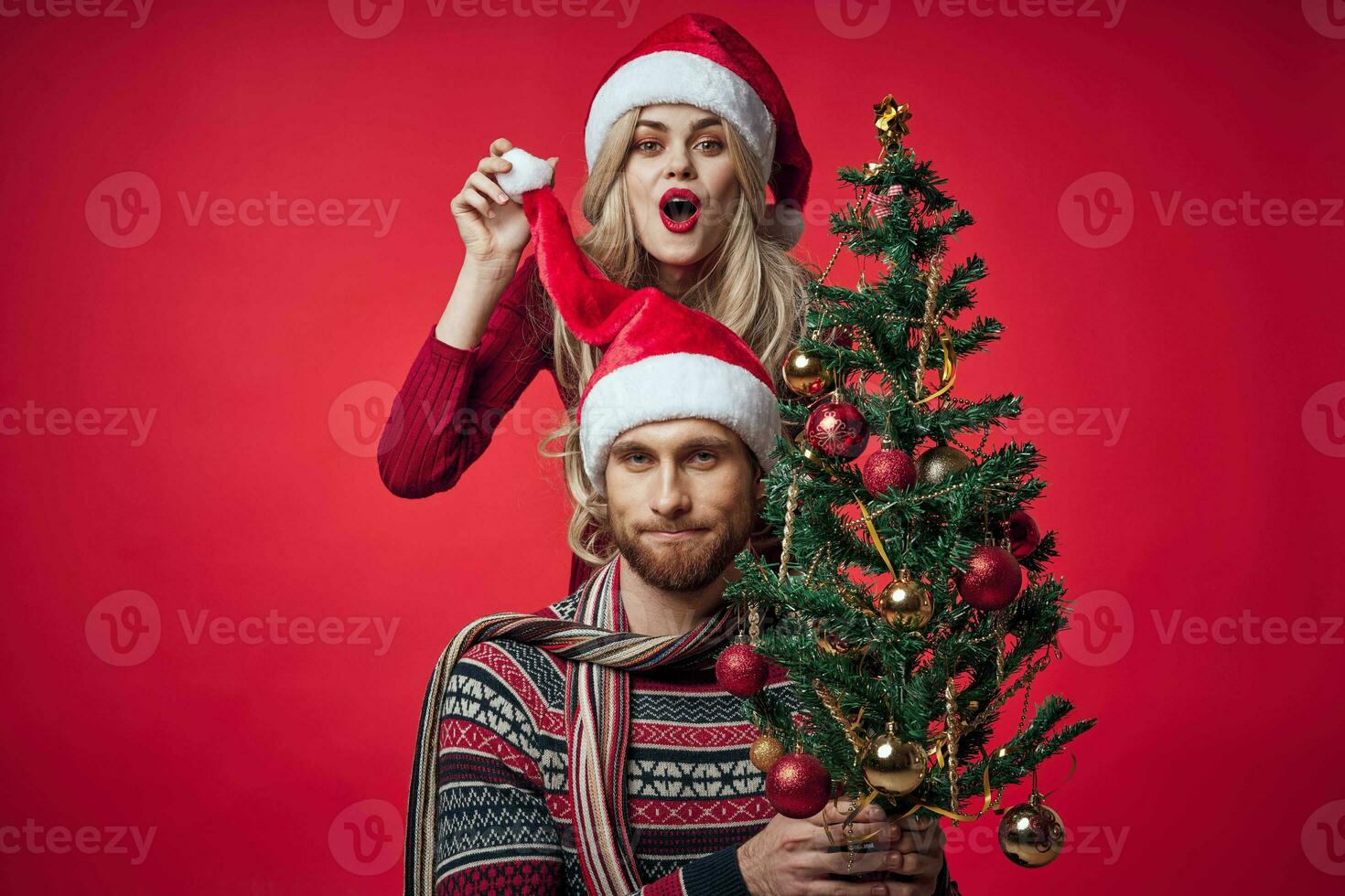 man and woman christmas clothes holiday gift red background photo