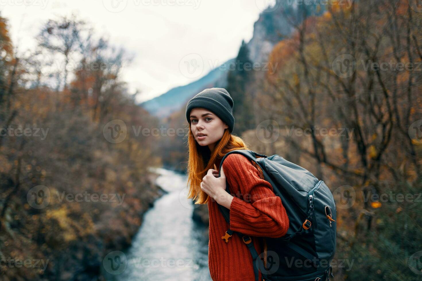 woman tourist backpack autumn forest river travel photo