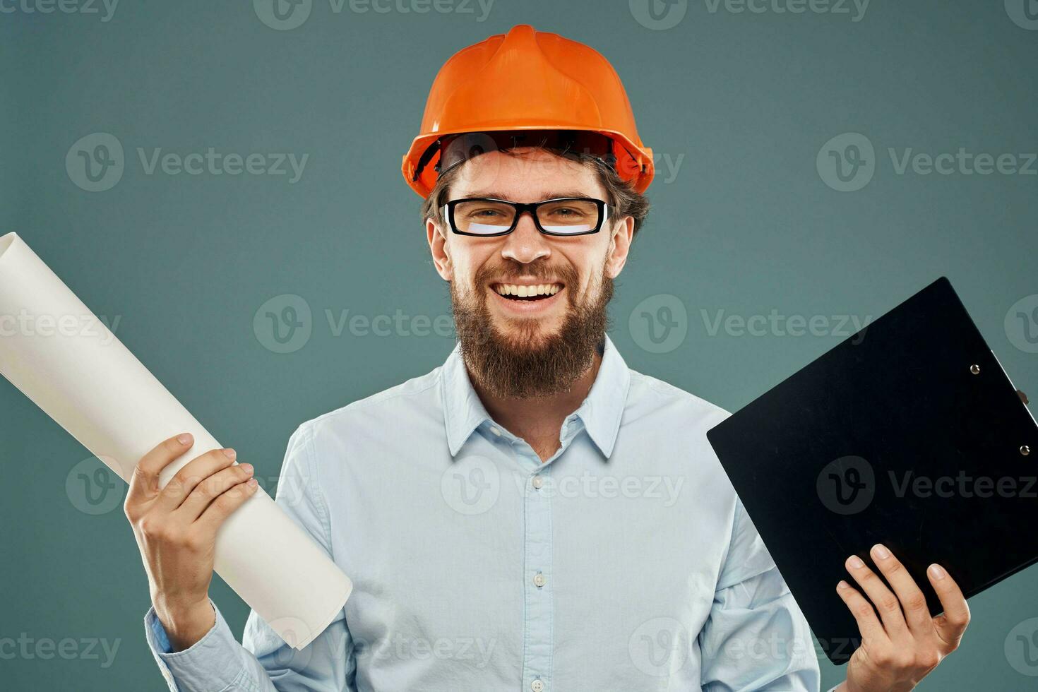 Cropped view of cheerful bearded man in orange paint in glasses with documents in hands photo
