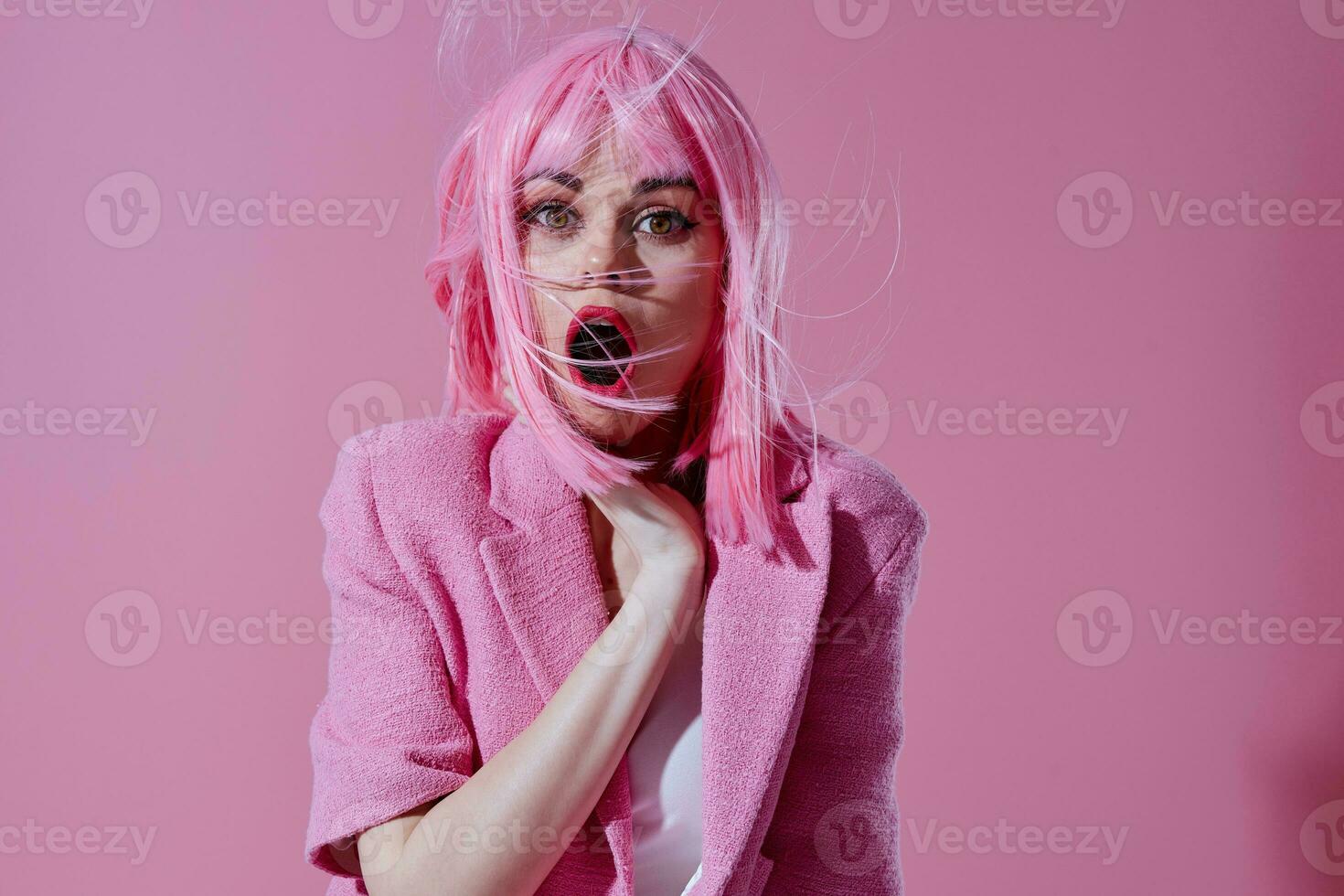 Beautiful fashionable girl in a pink blazer pink wig cropped view pink background unaltered photo