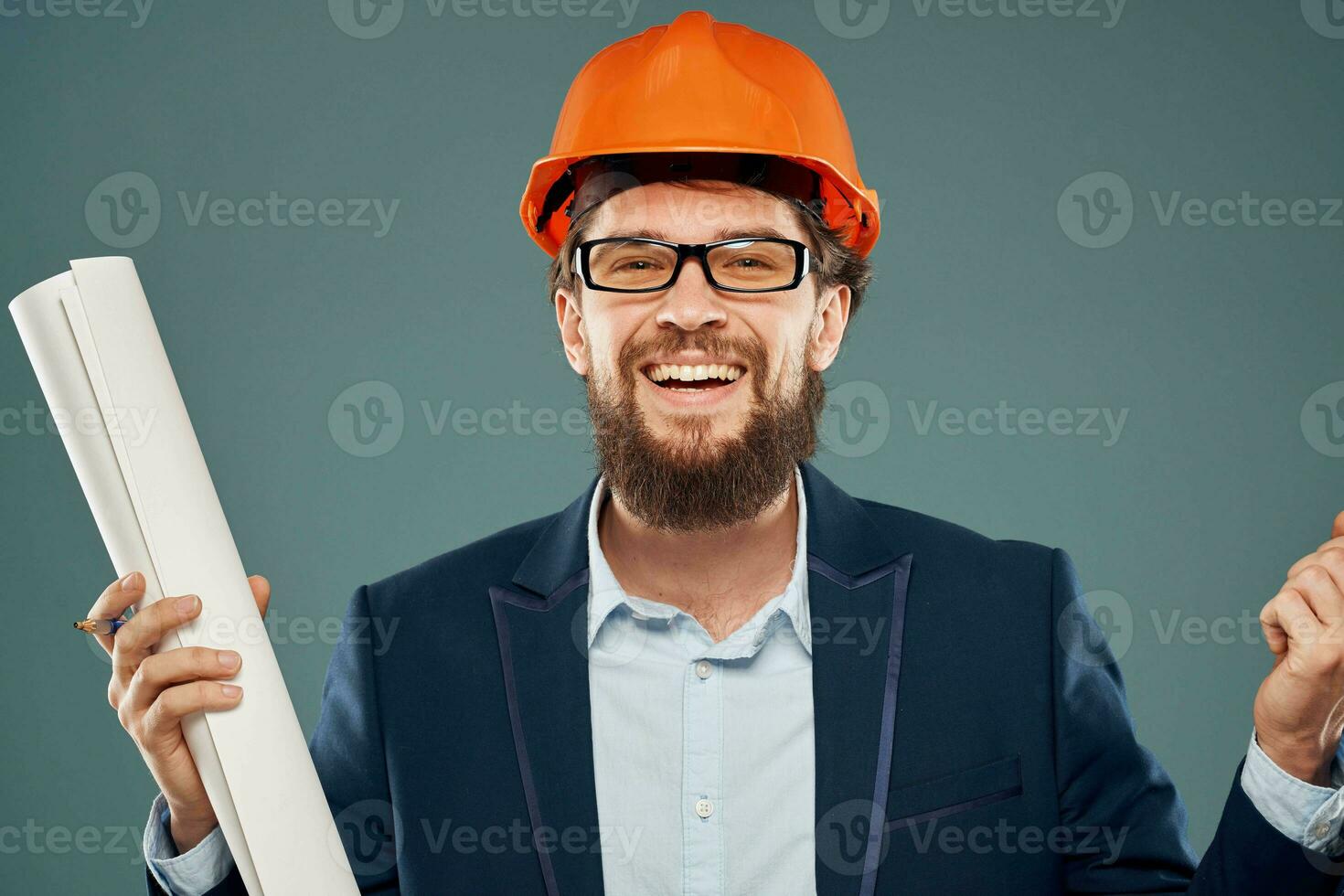 Cheerful man with blueprints in hands in orange helmet safety engineer cropped view photo
