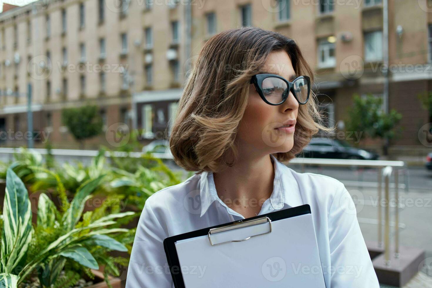 cheerful business woman documents communication on the street photo
