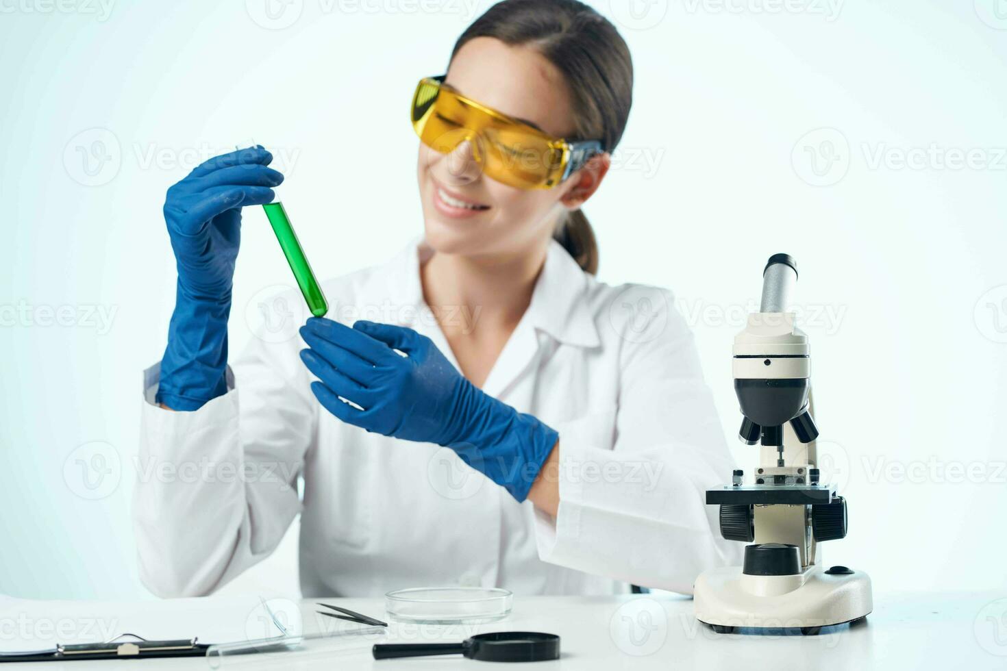 female laboratory assistant wearing yellow glasses chemical solution microscope research biotechnology photo