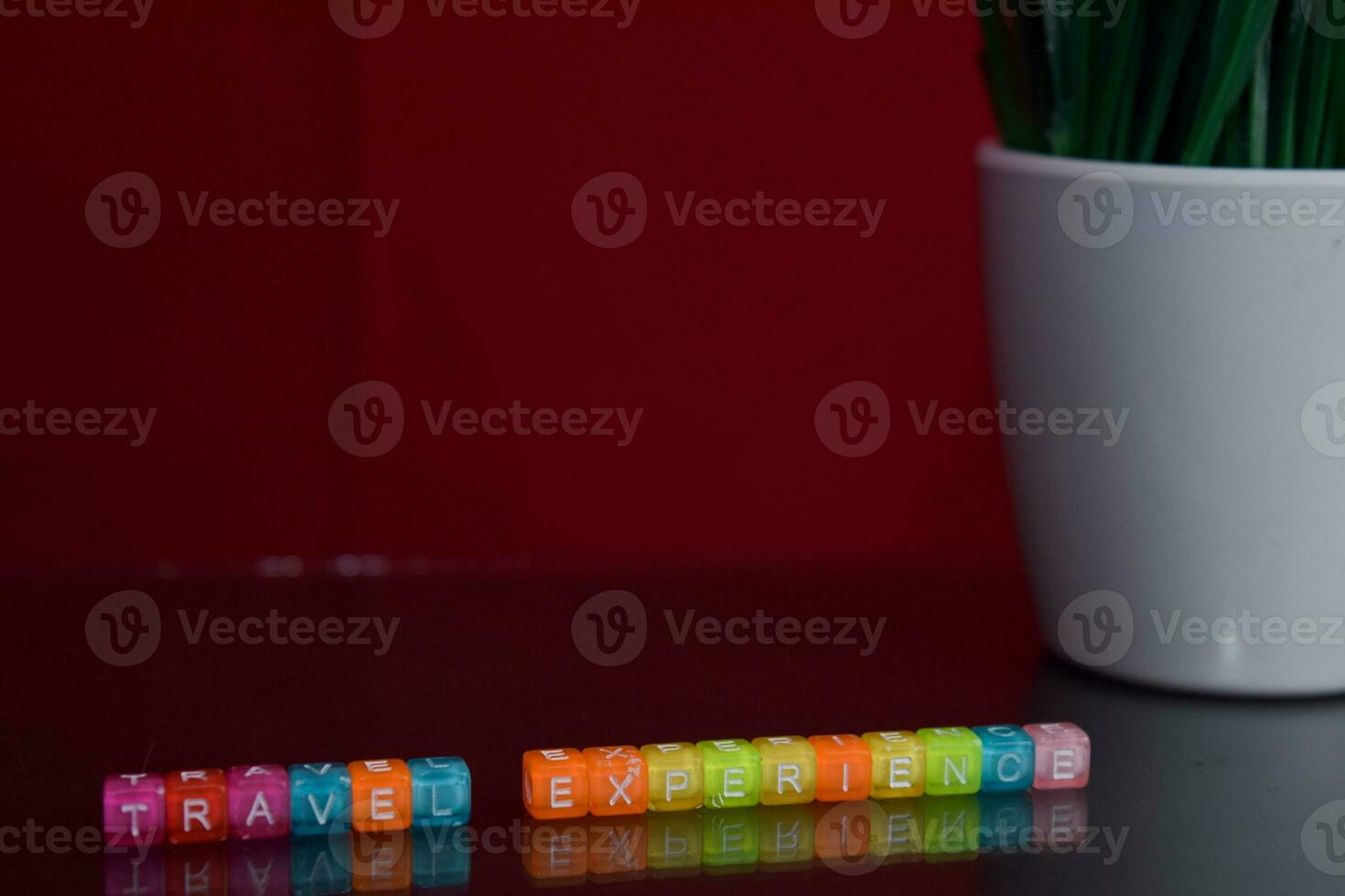 Travel experience text at colorful wooden block on red background. Desk office and education concept photo