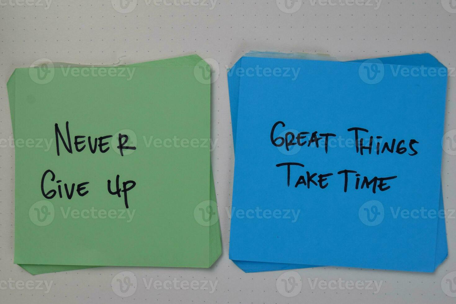 Never Give Up - Great Things Take Time write on sticky notes isolated on Wooden Table. photo