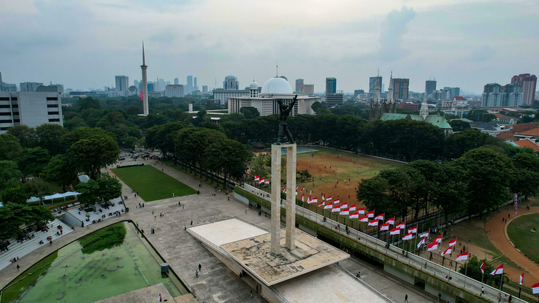 Aerial view of West Irian Liberation monument in downtown Jakarta with Jakarta cityscape. Jakarta, Indonesia, August 29, 2022 photo