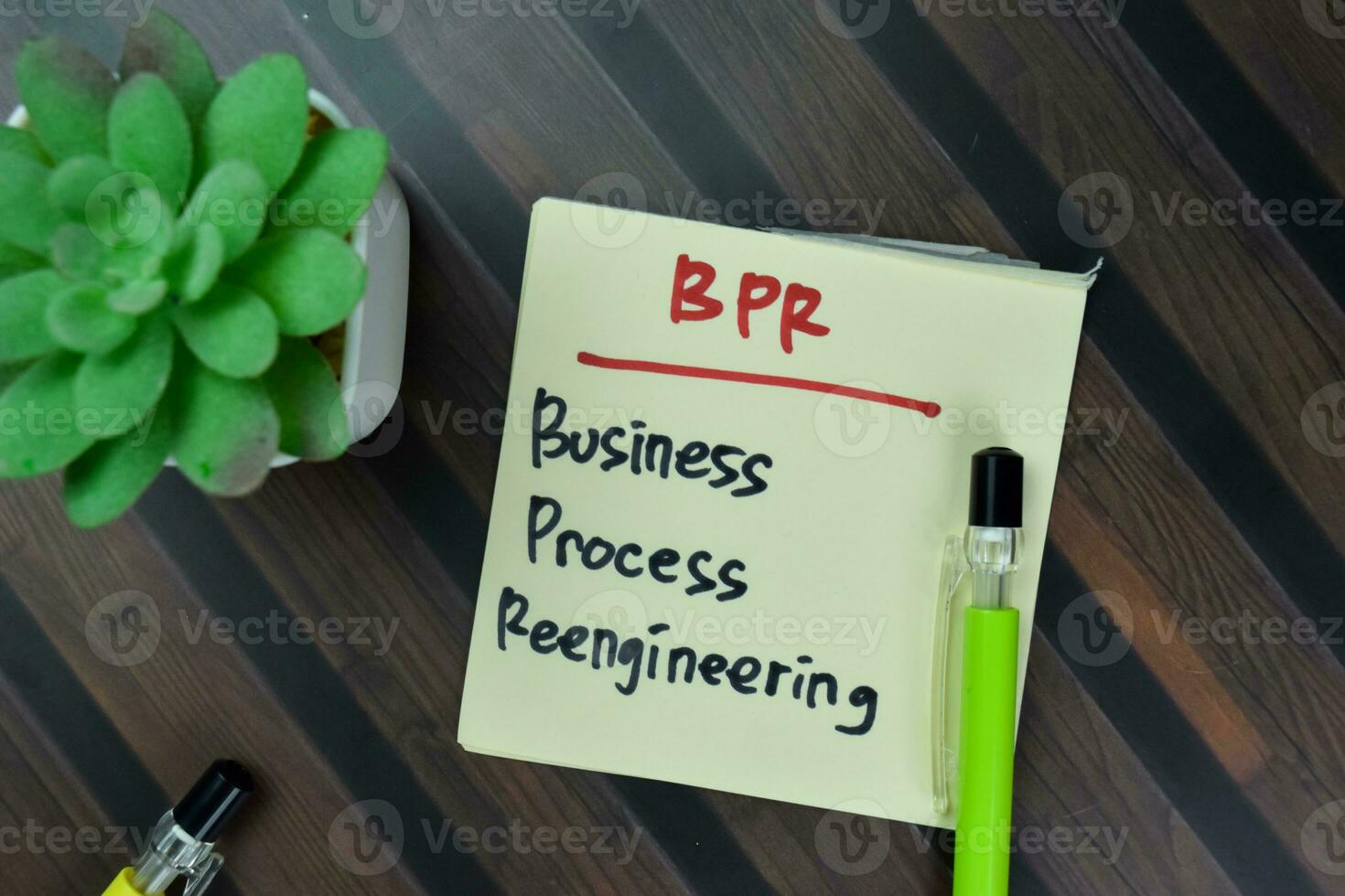 Concept of BPR - Business Process Reengineering write on sticky notes isolated on Wooden Table. photo