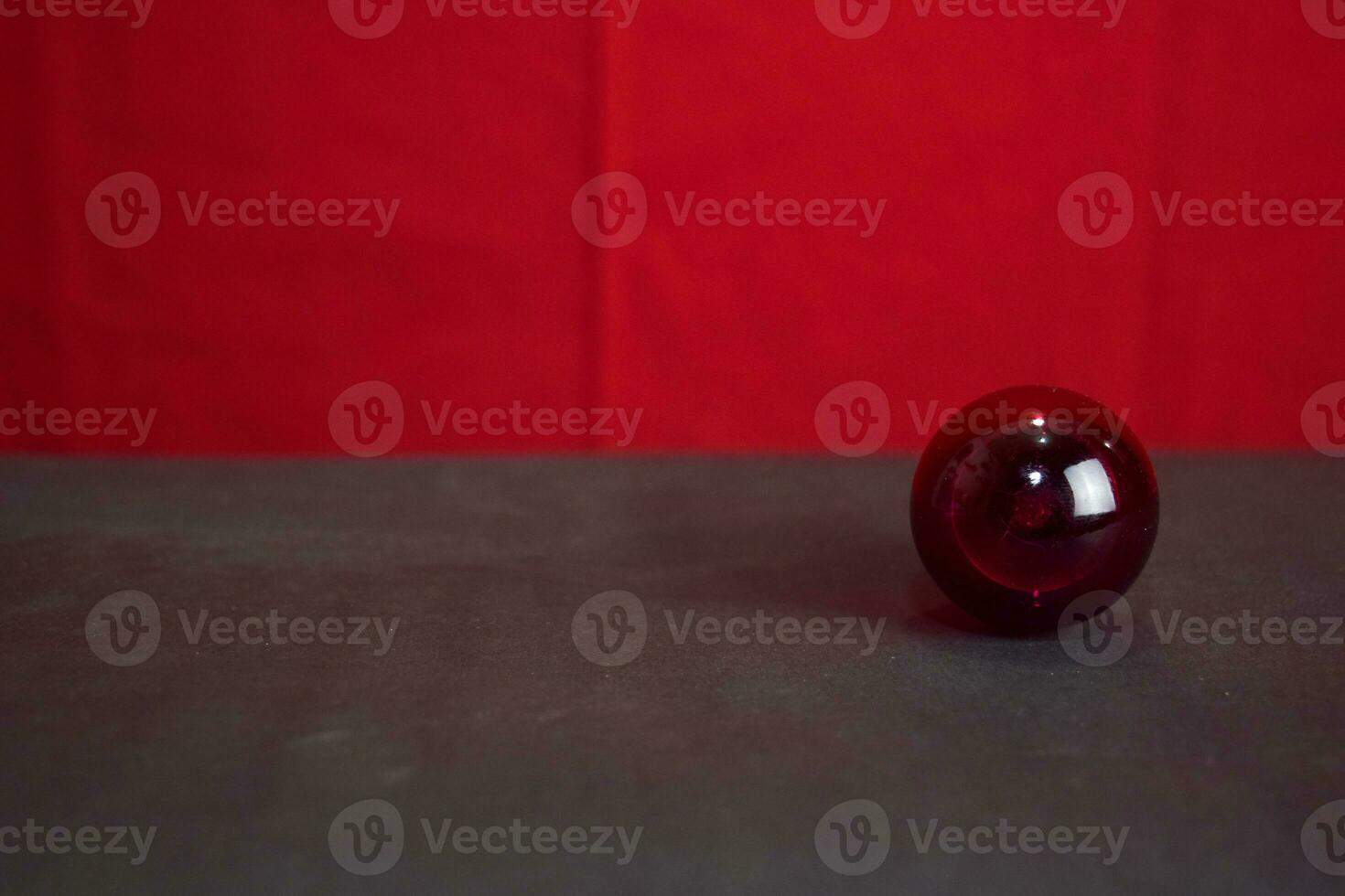 Close up lamp in red background and black table photo