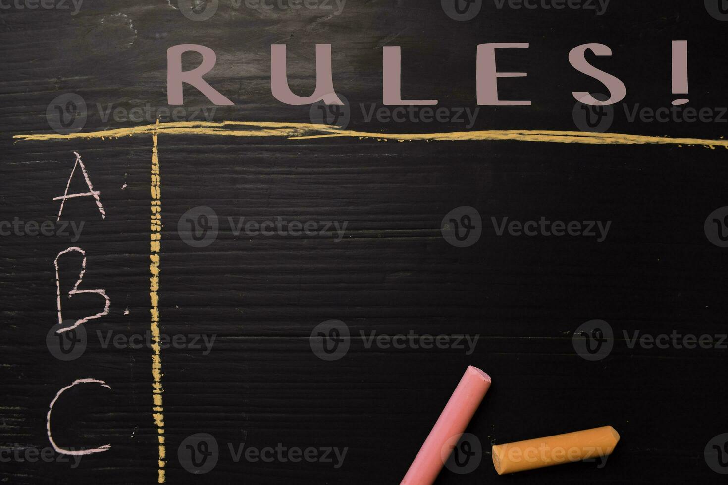 Rules written with color chalk. Supported by an additional services. Blackboard concept photo