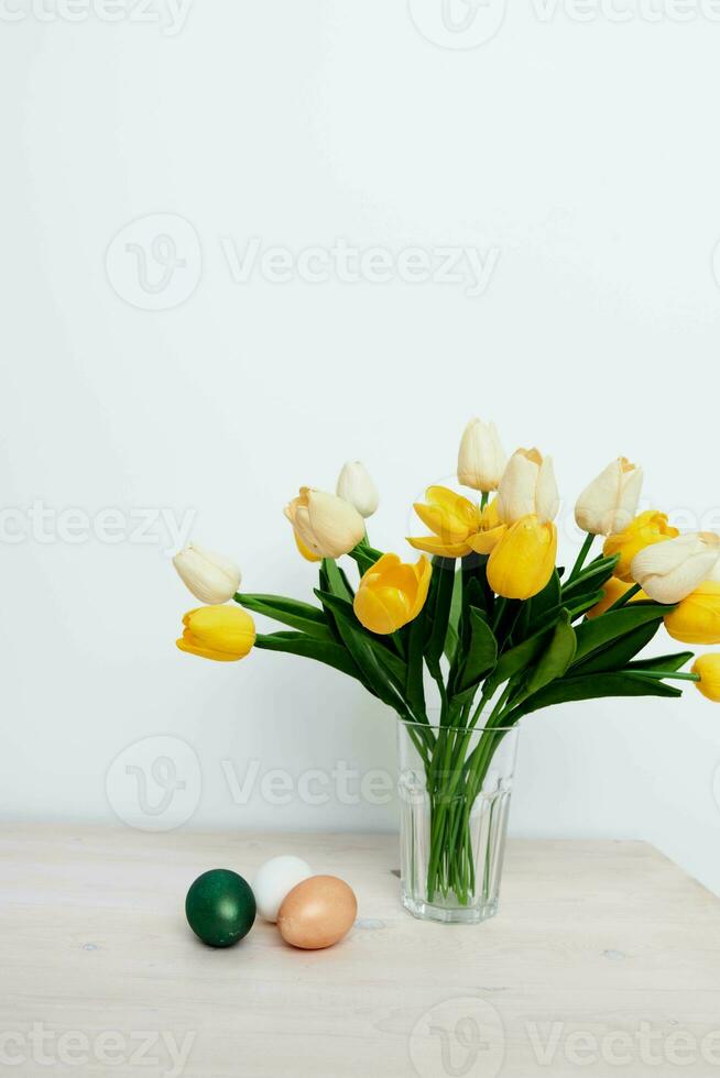 Easter holiday colorful eggs bouquet of flowers gifts photo