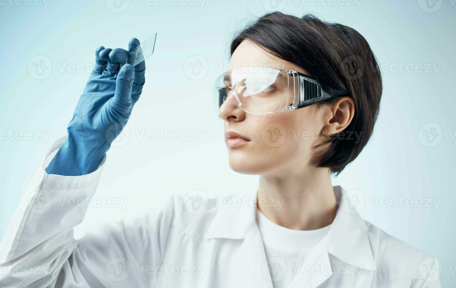 female laboratory assistant in a white coat analysis diagnostics biology photo