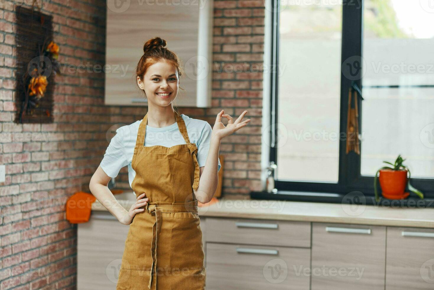 hermosa mujer en un marrón delantal cocina interior estilo de vida