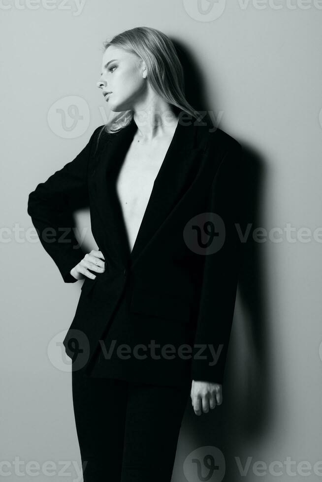 Young beautiful stylish girl posing leaning on the wall in the studio photo