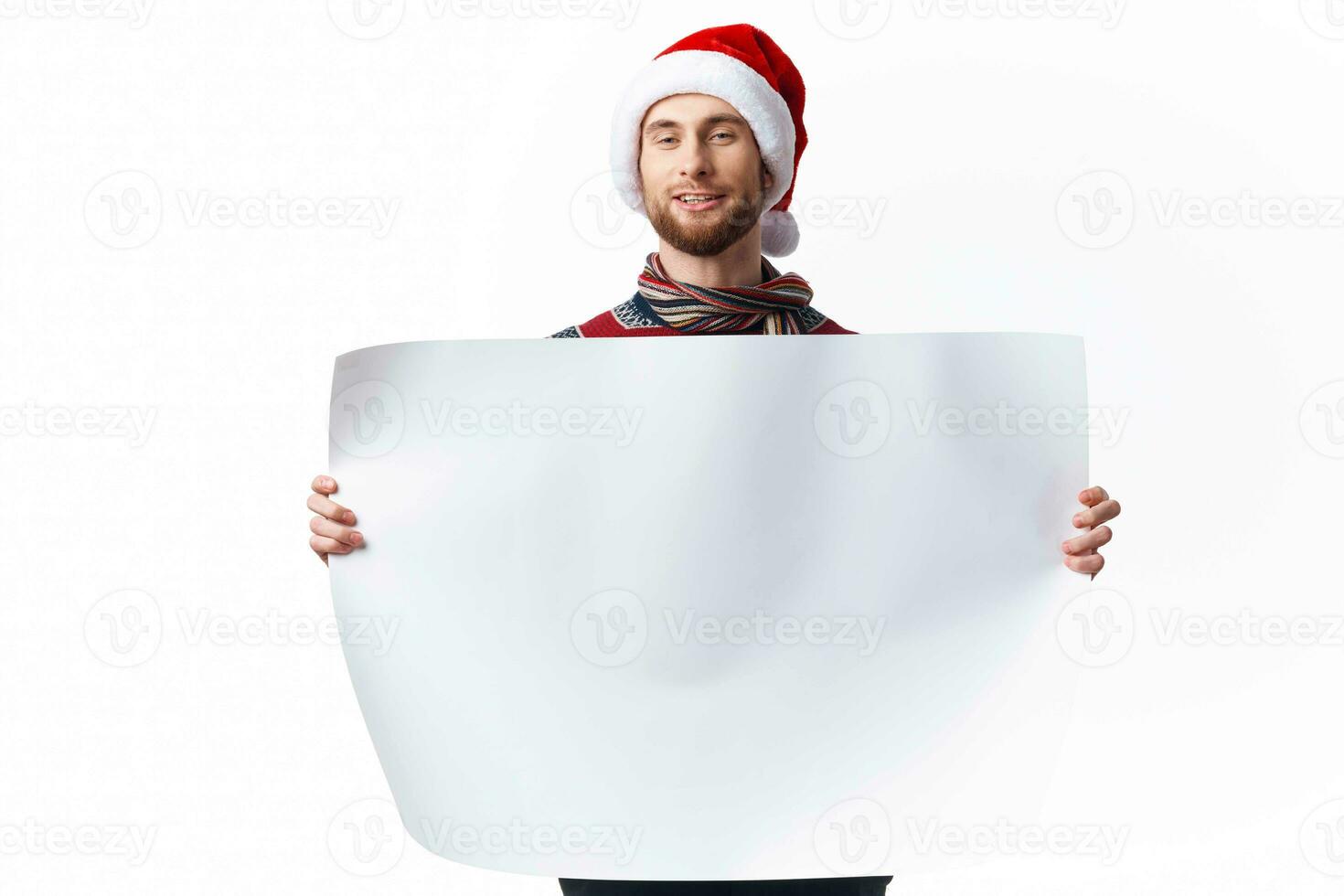 handsome man in New Year's clothes holding a banner holiday light background photo