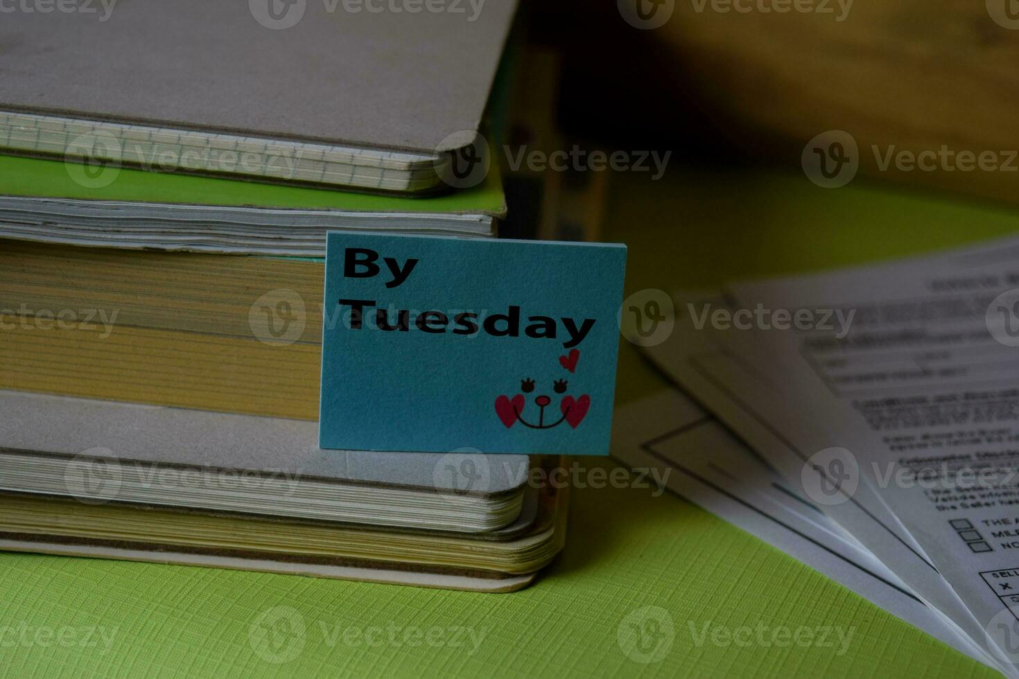 By Tuesday write on a sticky note isolated on Office Desk. Business Document concept photo