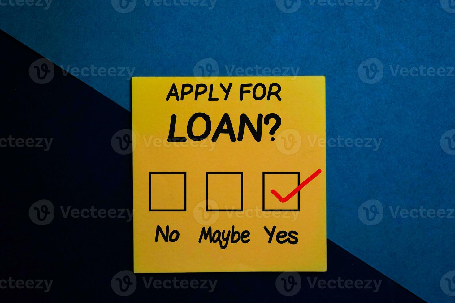 Apply for loan and check mark write on a sticky note isolated on Office Desk photo