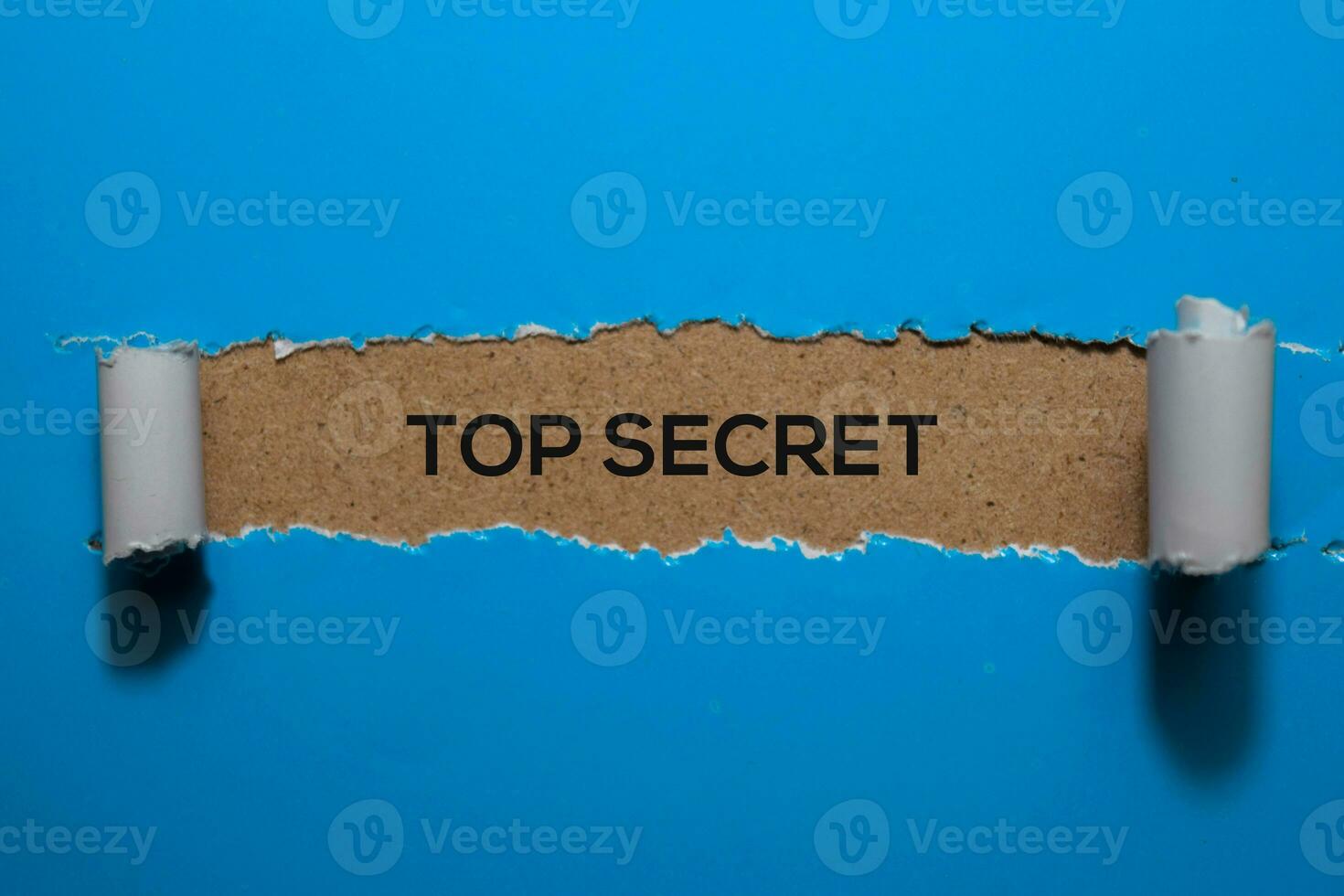 Top Secret write on blue torn paper photo