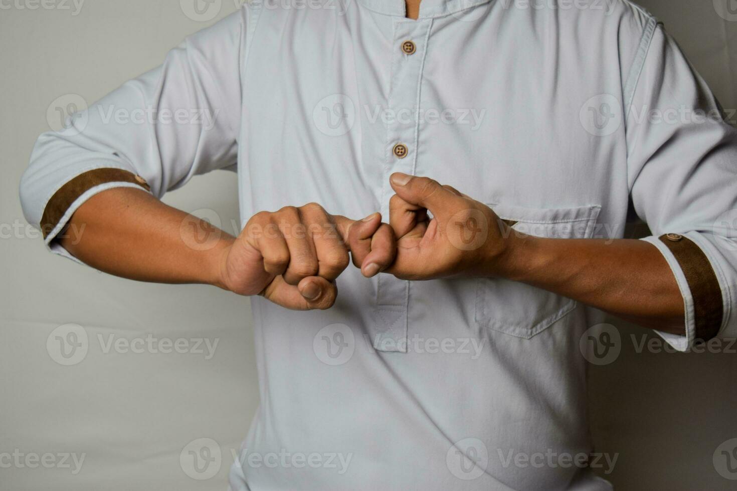 Close up Asian man shows hand gestures it means Friend isolated on white background. American sign language photo