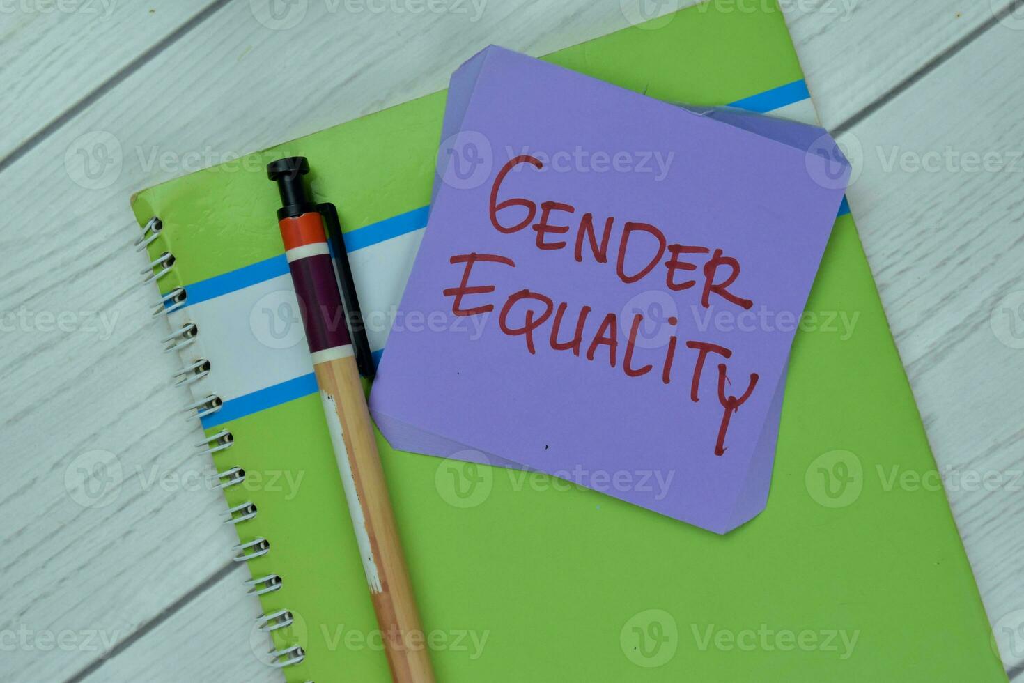 Concept of Gender Equality write on sticky notes isolated on Wooden Table. photo