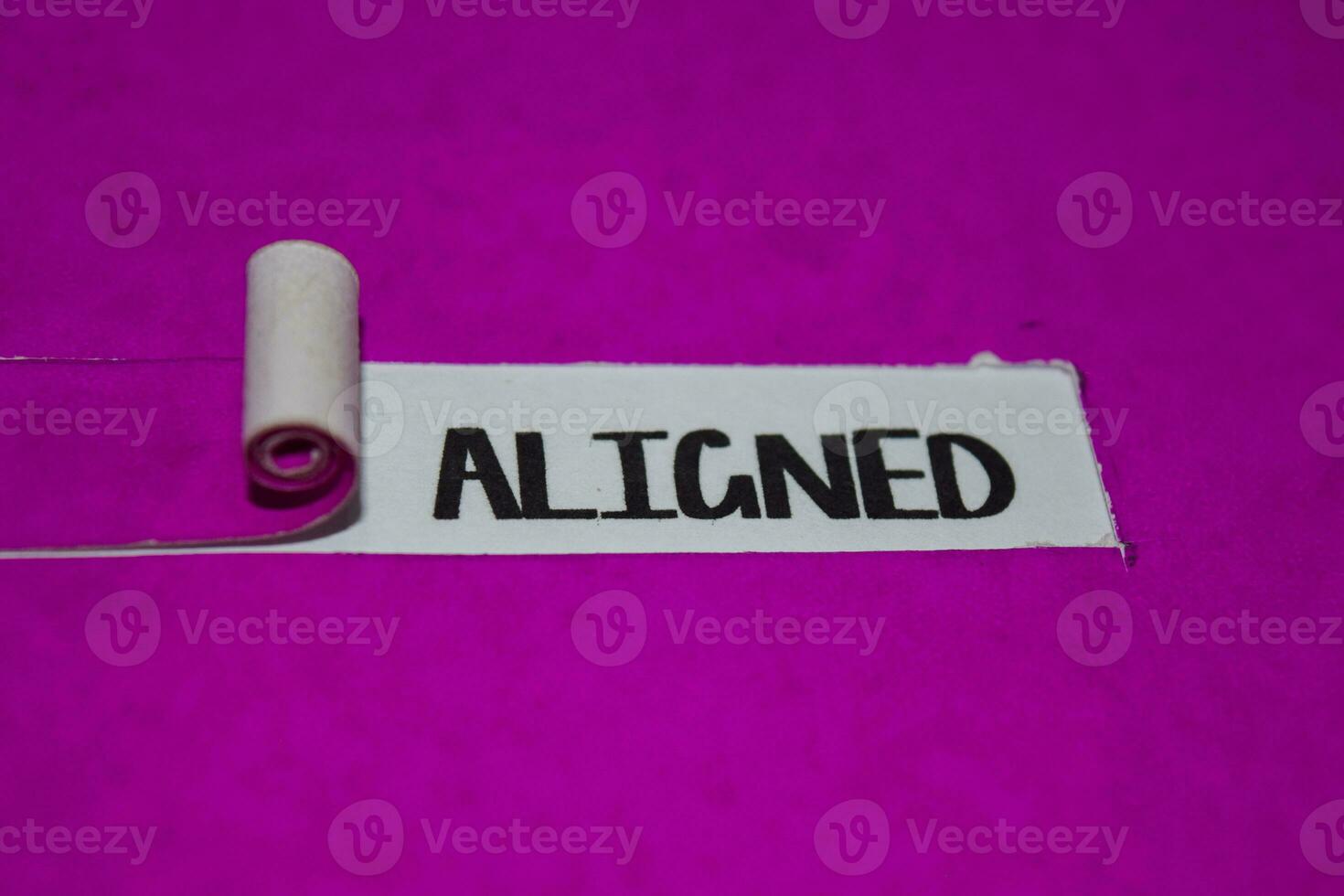 Aligned text, Inspiration and positive vibes concept on purple torn paper photo