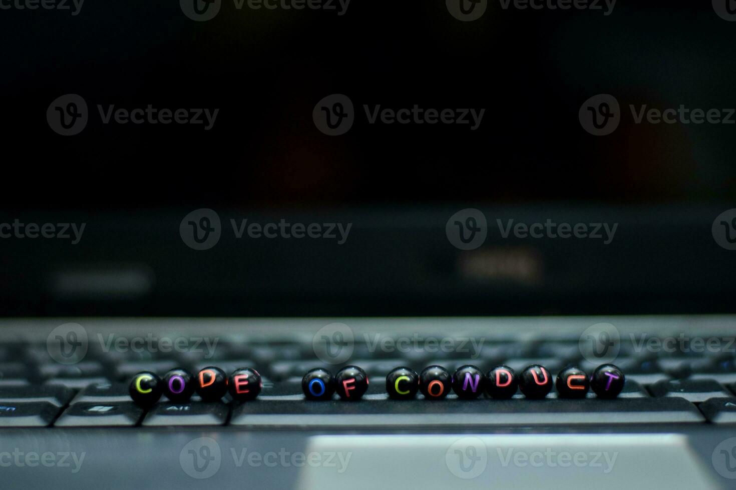Code of Conduct text wooden blocks in laptop background. Business and technology concept photo