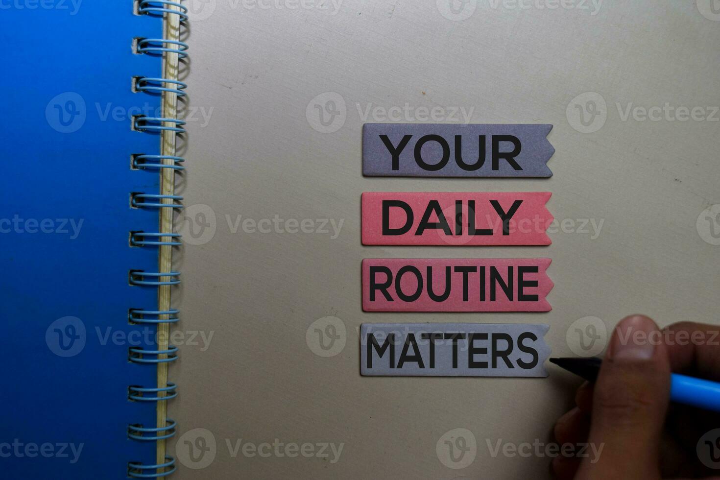 Your Daily Routine Matters. Handwriting on sticky notes on office desk photo