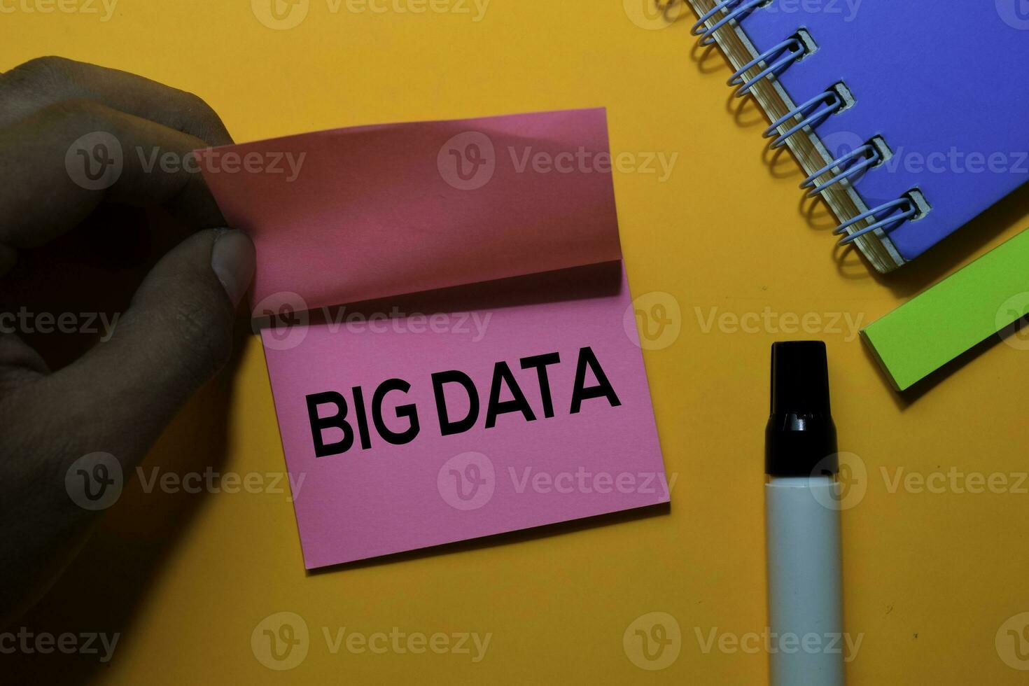 Big Data write on sticky notes. Isolated on orange table background photo