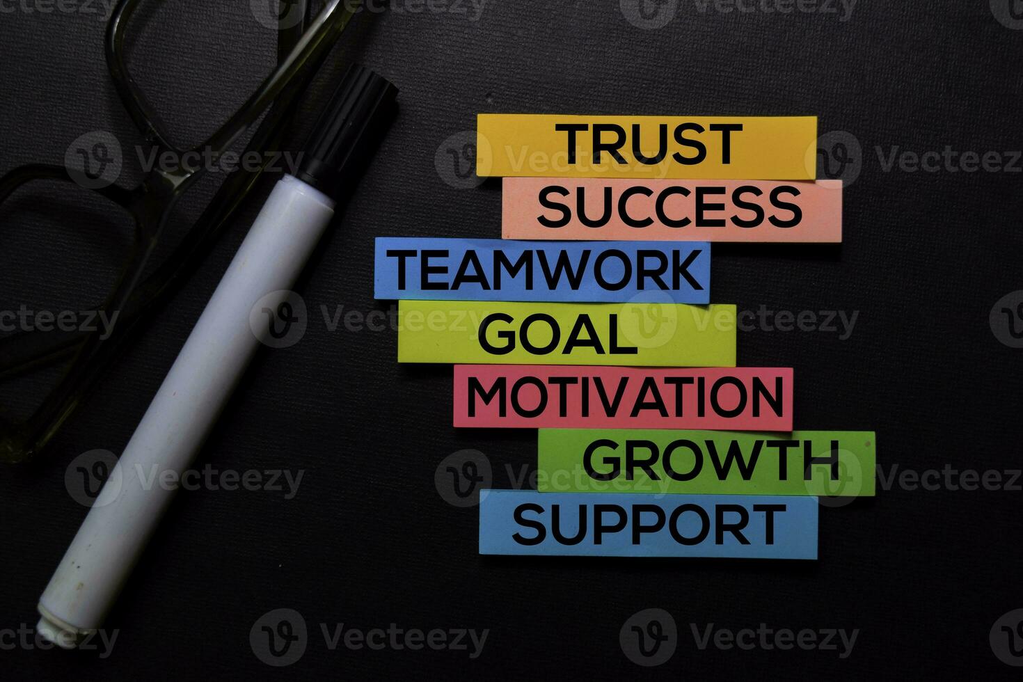 Trust, Success, Teamwork, Goal, Motivation, Growth, Support text on sticky notes isolated on Black desk. Mechanism Strategy Concept photo