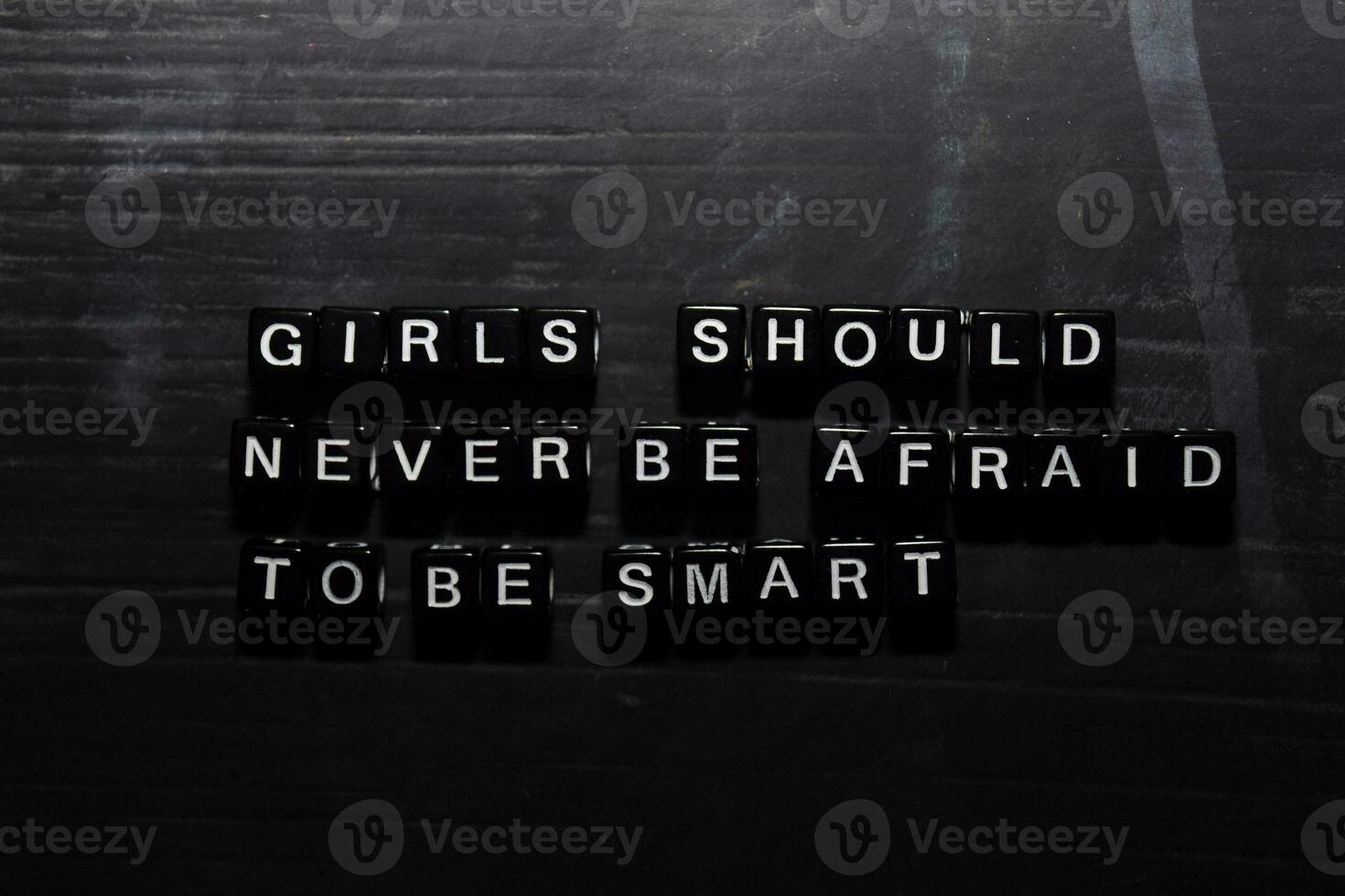 Girls should never be afraid to be smart on wooden blocks. Education, Motivation and inspiration concept photo