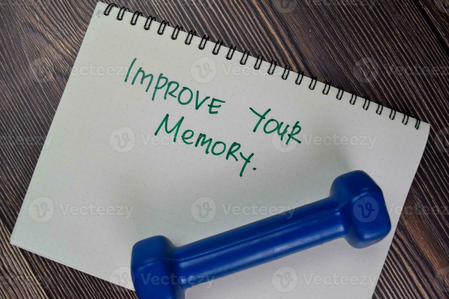 Improve Your Memory write on a book isolated on Wooden Table. photo