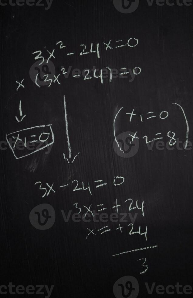 Close up math formulas written on a blackboard. Education concept photo