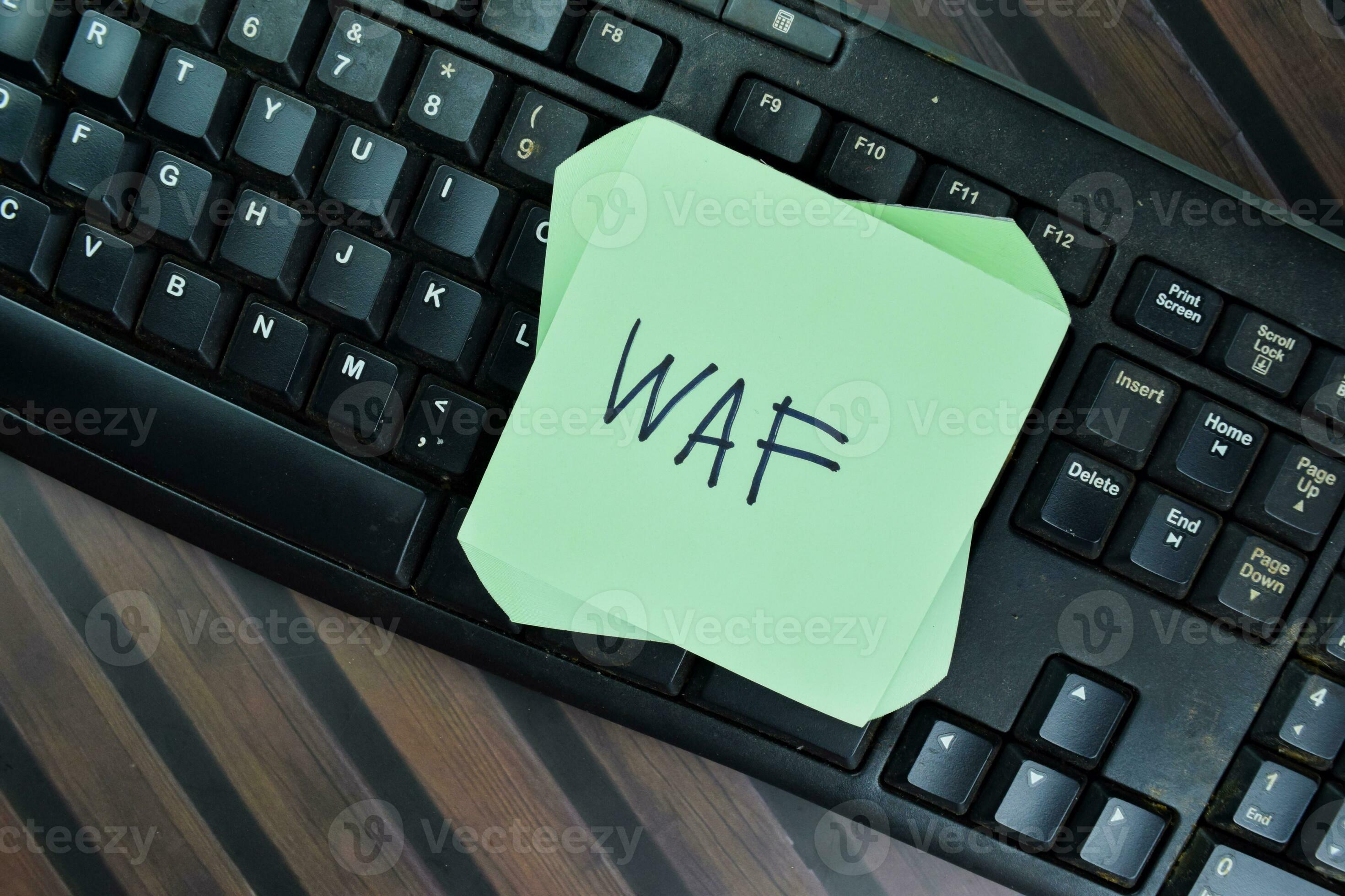WAF  Application Firewall write on sticky notes isolated on Wooden