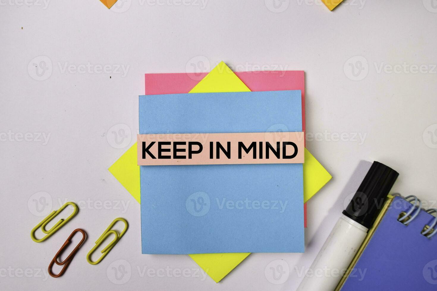 Keep in Mind on sticky notes isolated on white background. photo