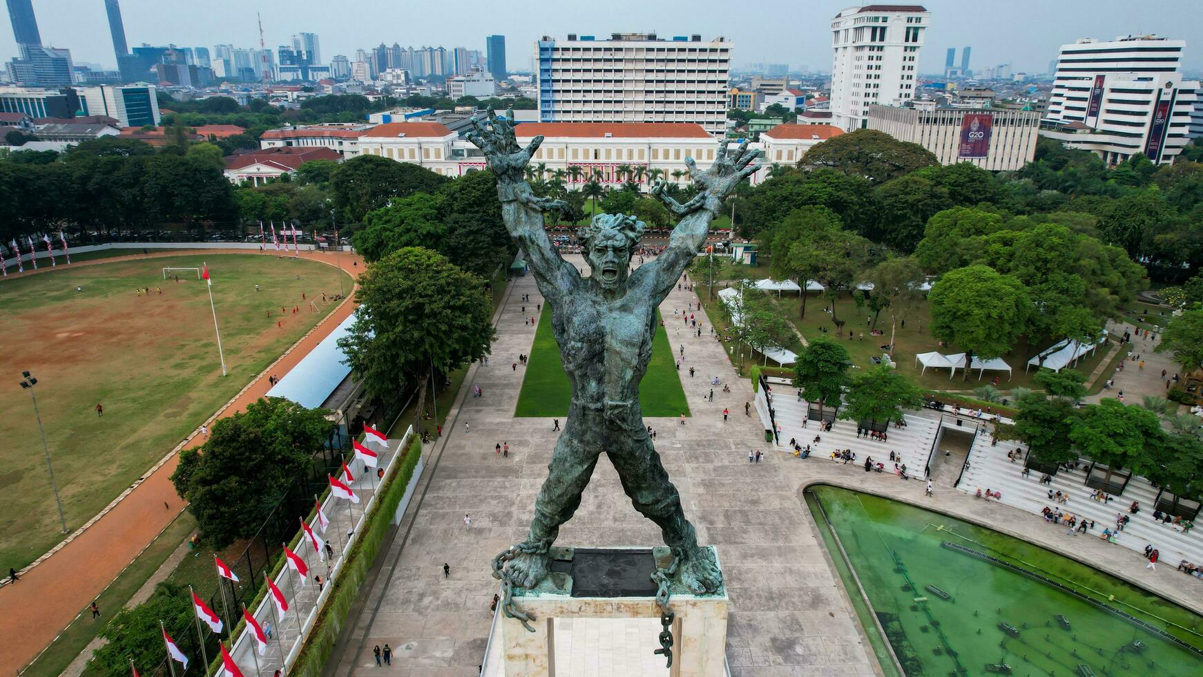 Aerial view of West Irian Liberation monument in downtown Jakarta with Jakarta cityscape. Jakarta, Indonesia, August 29, 2022 photo