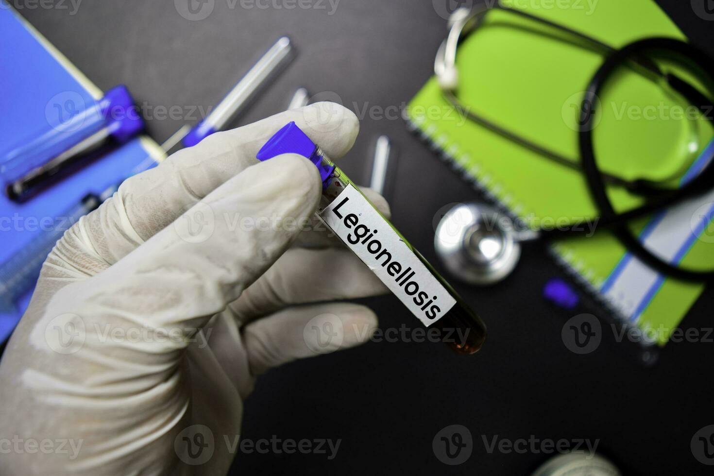 Legionelllosis text with blood sample. Top view isolated on black background. Healthcare Medical concept photo