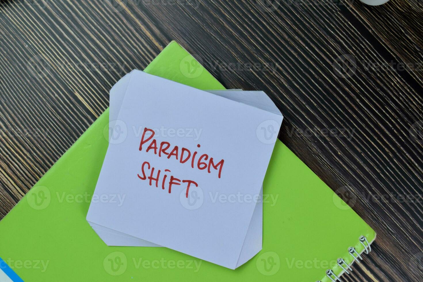 Paradigm Shift write on sticky notes isolated on Wooden Table. photo