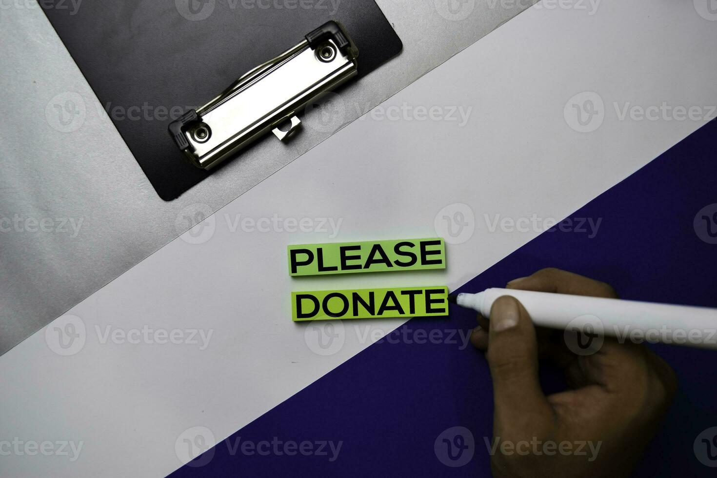 Please Donate text on sticky notes with color office desk concept photo
