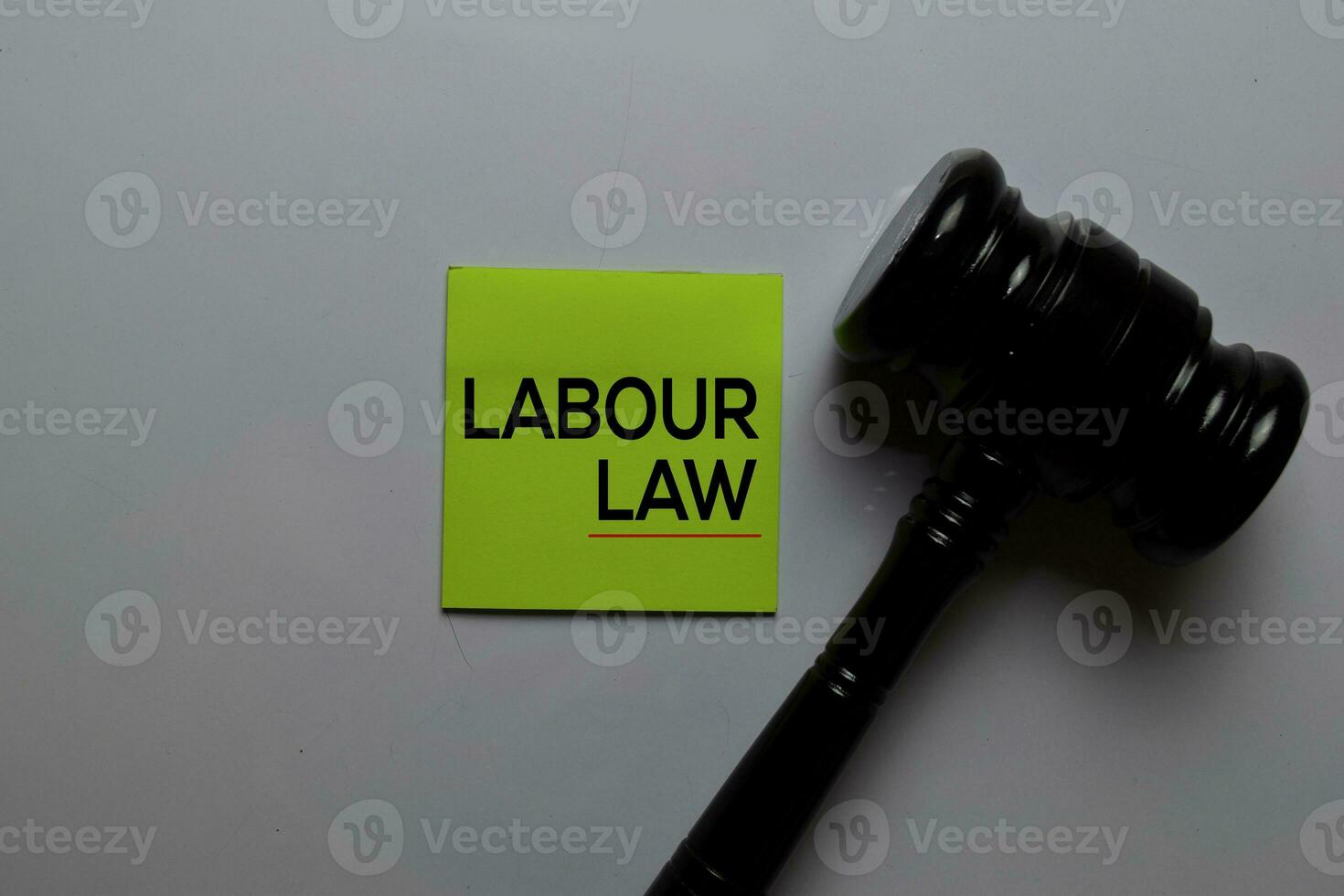 Labour Law write on sticky notes. Isolated on white table background photo