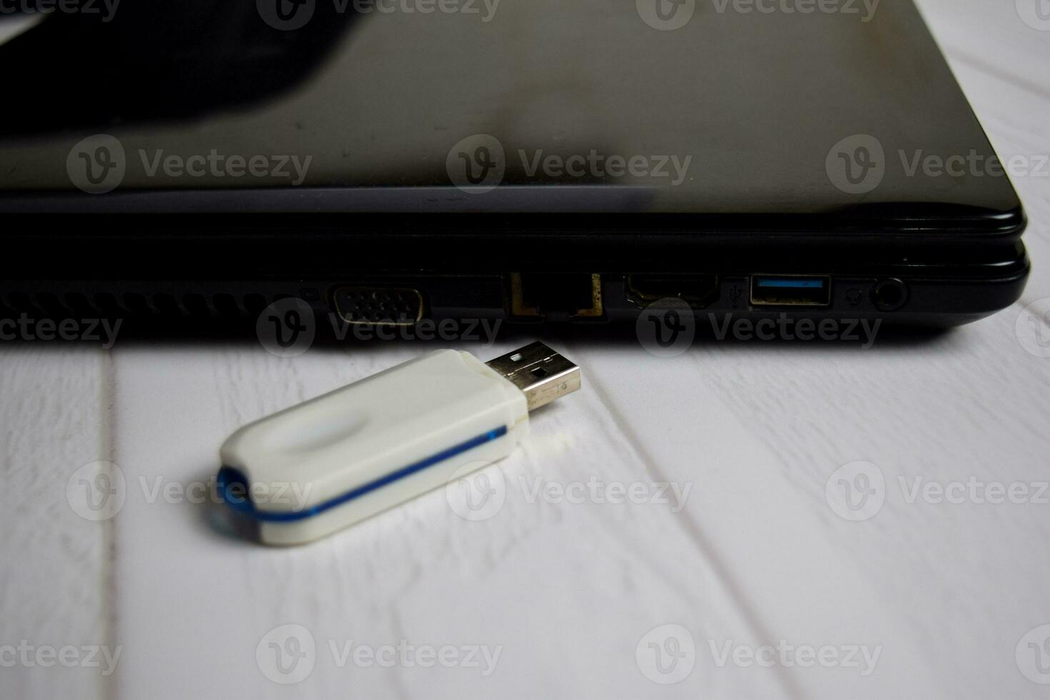 Flash drive connect to USB port plug-in laptop for transfer data concept isolated on office desk photo