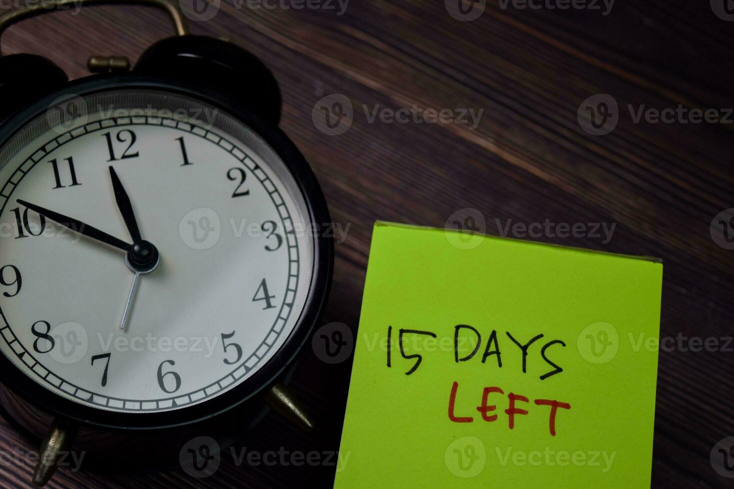 15 Days Left write on sticky note isolated on wooden table. photo