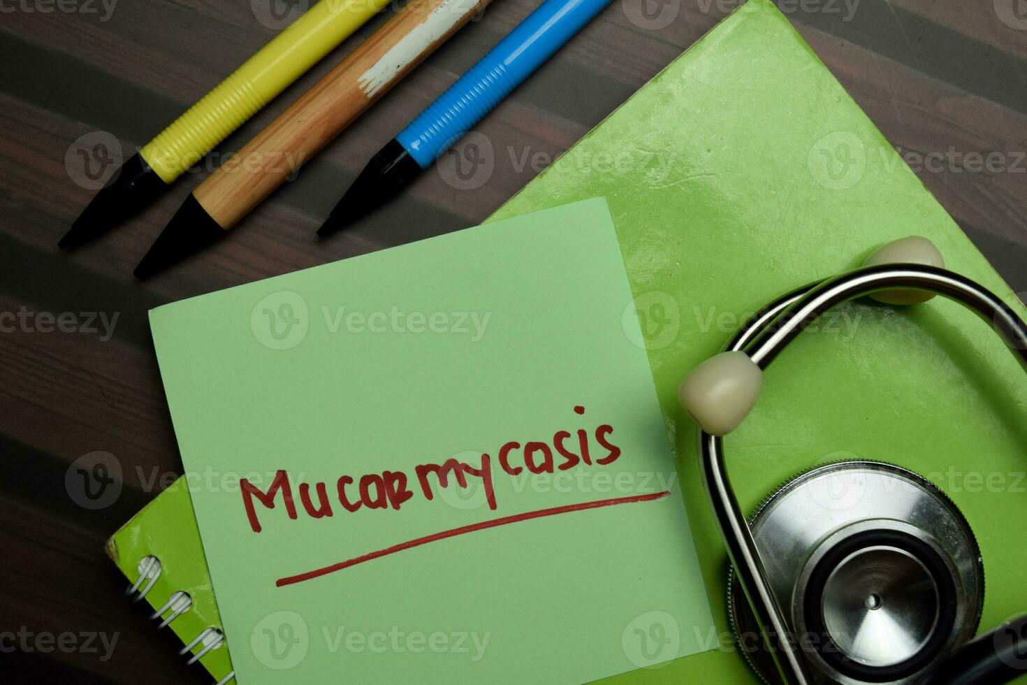 Mucormycosis write on sticky notes isolated on Wooden Table. photo